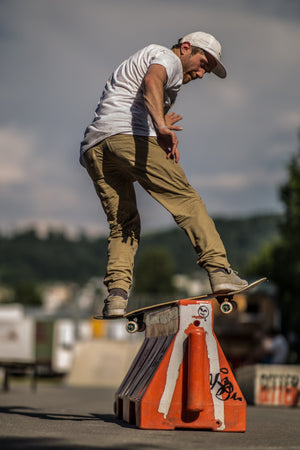 Skateboarder doing a Backside Board Slide in a park