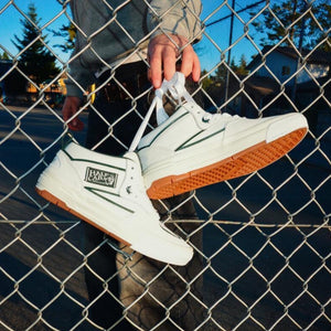 white gum vans half cab waffle cup lifestyle shoes on a fence image 