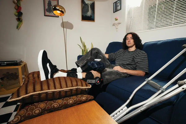 Rowan Zorilla sitting on the couch with his new Pro model Vans called the Rowan Z3 in Black White colorway