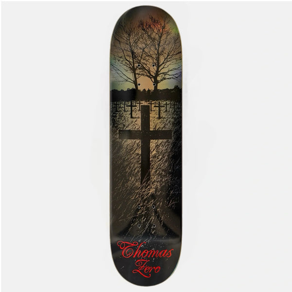 A black and gold Jamie Thomas zero skateboard deck with a cross and trees and rainbow gold foil finish