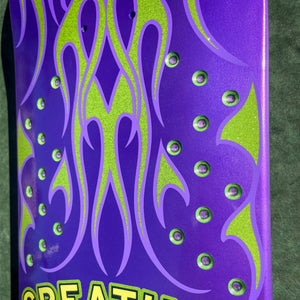 Purple and green skateboard deck with flame design on a green background