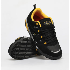 a pair of Es Symbol black yellow skate shoes                                                