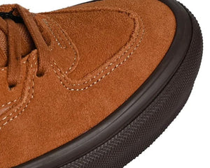 close up golden brown half cab skate vans