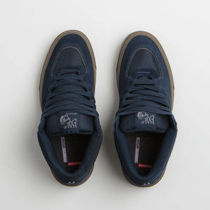 Pair of navy blue half cab waffle cup  sneakers with brown soles on a white background