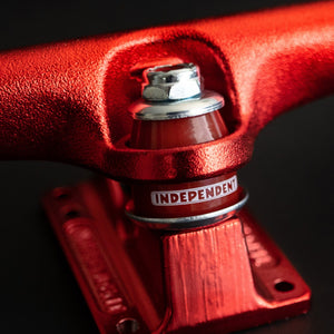 Independent red 10 inch skateboard trucks featuring classic Indy geometry and 90a cushions