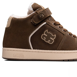Close-up of IPath Grasshopper Brown Shearling showing the side logo, brown upper and ankle strap