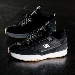 Black DC js2 Shanahan  sneakers with white soles on a dark surface