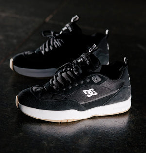 Black DC js2 Shanahan  sneakers with white soles on a dark surface