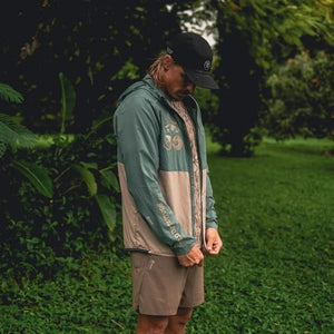 a lifestyle image of a man in the Roark second wind 3.0 green tan jacket 