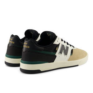 Black and beige new balance 306 cup sneakers with New Balance logo on a white background