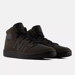 A pair of New Balance high-top sneakers in a dark brown and black colorway, featuring tonal black laces, a black midsole, and the signature 'N' logo on the side, set against a plain light gray background.