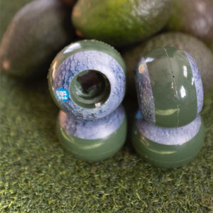 a set of green Oj avocado 58mm skateboard wheels
