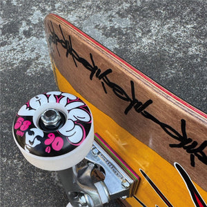 Close-up of Opera Fatties Torn Spike EX7 complete skateboard wheel, truck and deck construction