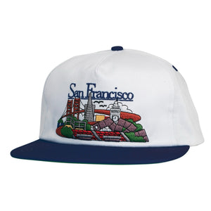 White  real skateboards cap with embroidered design of San Francisco landmarks on a white background