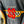 Close-up of a dark gray embroidered patch reading 'STUSSY SS COUPE' with red lettering, a checkered flag motif, and yellow trim on a garment.