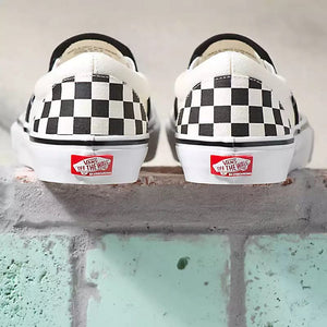 Rear view of Vans slip-on sneakers with black and white checkerboard pattern and white sole